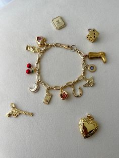 #charm #bracelets are back in #fashion. I am obsessed with the #gold in these! It looks so fabulous. My favorite charms are the #cherry and the #horseshoe. I also used the rest of the charms on my bag. To #janebirkenify it! I dont have a #birken just yet but still. Super #cute 🩵 I got all charms from #etsy and the ones i got are an #angel, #pomegranate, #cherry #cowboyboot #moon, #hand, #heart, #money, #evileye, and #horseshoe Cheap Sentimental Charm Bracelet As Personalized Gift, Luxury Dangling Charms Bracelet, Cheap Vintage Charm Bracelet Gift, Cheap Vintage Gold Charm Bracelet, Personalized Charm Bracelet For Friendship, Vintage Gold Charm Bracelet Luxury, Luxury Vintage Gold Charm Bracelet, Symbolic Gold Bracelets With Charms, Gold Plated Charm Bracelet With Removable Charms