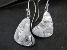 These earrings are made custom and made-to-order from sterling silver and copper Mokume Gane.  This ancient Japanese metalsmithing style is created by methodically layering different metals together, fusing them under extreme heat, and carving a unique pattern to reveal a beautiful good grain pattern.  Due to the process, each piece is highly unique and may vary slightly from the image shown. Each pair of earrings comes on hand made sterling silver French wire earrings. Matching pendant: https://www.etsy.com/listing/798856549/mokume-pendant?ref=shop_home_active_5&frs=1 Matching Pendants, Earrings Matching, French Wire Earrings, Mokume Gane, Extreme Heat, French Wire, Wire Earrings, Unique Patterns, Jewelry Earrings Dangle