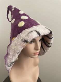 Beautiful felted toadstool hat. Made by myself with very soft Australian Merino wool. Purple with white and yellow dots. Striped inside. Can be folded over to reveal striped side. Whimsical Winter Hat With Short Brim, Whimsical Wide Brim Winter Hat, Purple Whimsical Winter Hat, Whimsical Purple Winter Hat, Whimsical Winter Hats With Curved Brim, Handmade Wide Brim Winter Costume Hats, Handmade Wool Felt Hat For Winter, Unique Winter Brimmed Hat, Unique Brimmed Winter Hat