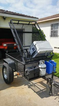 a truck with two coolers on it parked in front of a house