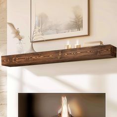 a fireplace mantle with two lit candles on it