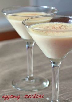 two glasses filled with liquid sitting on top of a table