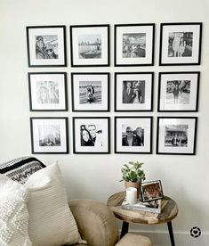 a living room with pictures on the wall and a small table in front of it