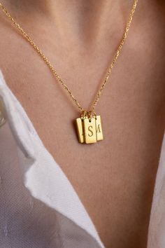 Elevate your everyday style with this elegant 14K gold initial tag necklace, featuring three customizable charms engraved with your chosen initials. This charm necklace is perfect for those who love modern gold jewelry with a personal touch. Whether you’re layering it with other pieces or wearing it solo, this versatile necklace makes a chic statement. Ideal as a personalized gift for her, this gold jewelry piece effortlessly complements both business casual outfits and everyday wear, adding a hint of gold aesthetic to your look Gold Charm Necklaces With Initial Pendant For Personalized Gift, Elegant Personalized Gift Initials Charm Necklace, Elegant Charm Necklace With Custom Name Initial Pendant, Engraved 14k Gold Initial Pendant Name Necklace, Custom Gold Jewelry, Minimalist Necklace Gold, Modern Gold Jewelry