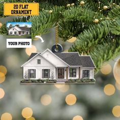 a white house ornament hanging from a christmas tree