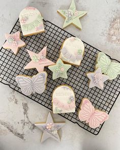 some decorated cookies are on a cooling rack