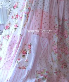 a pink and white dress with flowers on it is hanging in front of a window