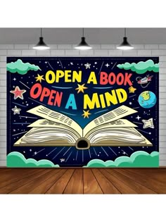 an open book with the words open a mind on it in front of a brick wall