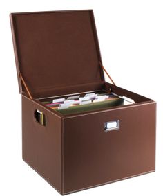 a brown leather storage box filled with files