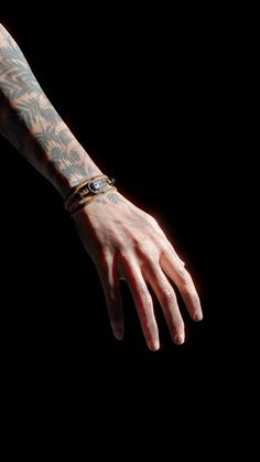 a man's arm and hand with tattoos on it