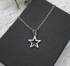 "This is a pretty minimalist star necklace - so pretty and great for layering. See all my stainless steel necklaces: https://www.etsy.com/shop/AlwaysPrettyThings?ref=seller-platform-mcnav§ion_id=21348272 Stainless steel is a darker metal than the bright sterling silver or silver plate. Stainless steel will not tarnish - you can wear it every day and it is perfect for sensitive skin.  ❤️ ADD ON UPGRADE SECTION for extras: https://www.etsy.com/shop/AlwaysPrettyThings?section_id=14811990&ref=shopse Star-shaped Stainless Steel Necklace For Gift, Stainless Steel Star Charm Necklace, Minimalist Silver Star Charm Necklace, Minimalist Necklace, Stainless Steel Necklace, Star Necklace, Stainless Steel Chain, Charm Necklace, Sensitive Skin