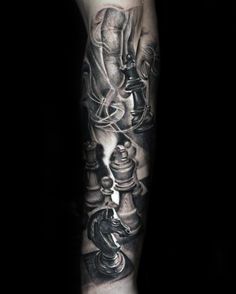 a man's arm with chess pieces on it