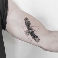 an eagle tattoo on the left arm