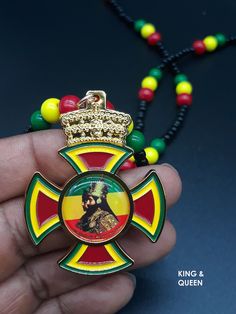 Emperor Haile Selassie I Beaded NecklacesGold plated and painted with pictures of the King in the centerSize: 1 3/4" w x 2" hThe necklace has a small screw to open and close the necklace so that you could put it on your neck and take it off... THESE NECKLACES CANNOT BE SENT TO A PRISON FACILITY DUE TO PENDANT BEING METAL. ZIONGATES Caribbean & Afrocentric Gift items Emperor Haile Selassie, Rasta Earrings, Queen Necklace, African Mythology, Haile Selassie, Metal Cross, King And Queen, Lion Of Judah, Black Art Pictures