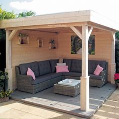 an outdoor living area with couches and tables