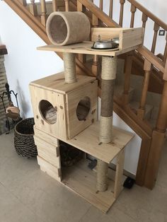 a cat tree in the middle of a staircase