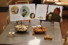 two children's books are on display in a room with wooden chairs and tables