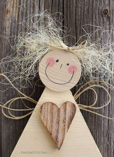 a wooden angel ornament with a heart on it's chest and hair in the shape of a face