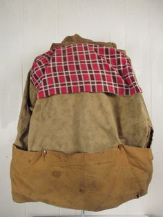 "Vintage 1940s hunting jacket, hooded coat. Made of brown camouflage cotton. Has a corduroy zippered split hood, chinstrap, four pockets, back game pouch, cotton flannel lined cowl and a button front. No label. Size large. Actual measurements are: 52\" at the chest 52\" at the waist 21\" shoulder seam to shoulder seam 22\" shoulder seam to end of cuff 26.5\" overall length In very good condition, nice natural fade." Vintage Hooded Hunting Outerwear, Vintage Hooded Outerwear For Hunting, Fall Hooded Hunting Jacket With Pockets, Fall Hunting Hooded Jacket With Pockets, Vintage Long Sleeve Parka For Hunting, Hooded Cotton Hunting Outerwear, Vintage Utility Jacket For Hunting In Fall, Military-style Brown Hunting Outerwear, Vintage Camouflage Outerwear For Outdoor