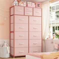 a child's bedroom with pink furniture and accessories