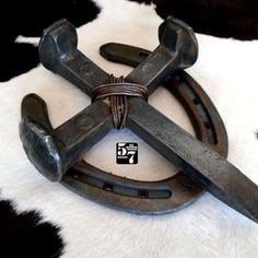 an old pair of scissors sitting on top of a cowhide rug