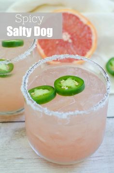 two glasses filled with pink margaritas and garnished with green peppers on the rim