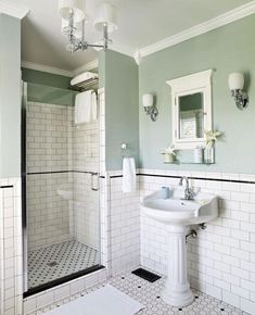 a bathroom with green walls and white tile on the floor is pictured in this image