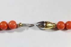 -Vintage 18k Gold Natural 9.4mm Orange Coral with Diamond Beaded Necklace -Total length: 19.75 in -Bead size: 9 mm ~ 9.85 mm -Diamond size: 1.15 mm -Total weight: 63.7 g -Marked 750 -Total of 16 small diamonds on the clasp -The clasp have the mix of yellow gold and white gold Luxury Yellow Gold Beaded Necklaces For Formal Occasions, Luxury Yellow Gold Beaded Necklace For Formal Occasions, Formal Yellow Gold Beaded Necklace, Antique Orange Necklaces With Polished Beads, Orange Vintage Jewelry With Faceted Beads, Vintage Orange Gemstone Beads, Vintage Orange Large Beads, Vintage Hand-strung Orange Beads, Orange Coral