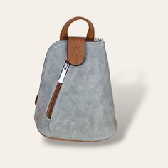 This SMALL grey & brown soft Italian backpack is ideal for when you need a bag that is both practical but also very stylish. This SMALL backpack has been handmade by artisans, and is a perfect bag to for all those essentials such as smartphone, cards, keys and make-up. It is fully lined with an internal zipped pocket for the things you like to keep safe & secure. It also has an additional zipped pocket on the front of the bag. The backpack can be used in the traditional way, or can also be used Versatile Gray Backpack With Zipper Closure, Versatile Gray Backpack For Daily Use, Gray Shoulder Backpack With Adjustable Strap, Gray Softback Backpack For Everyday Use, Gray Softback Backpack With Adjustable Strap, Everyday Gray Shoulder Backpack, Gray Shoulder Bag Backpack For Daily Use, Gray Satchel Backpack For Everyday Use, Everyday Gray Satchel Backpack