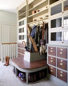 an organized closet with shoes, coats and umbrellas