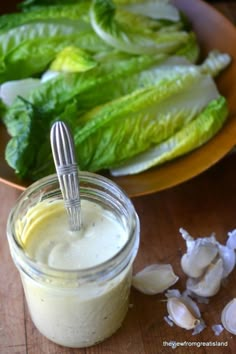 lettuce and garlic dressing in a jar on a wooden table