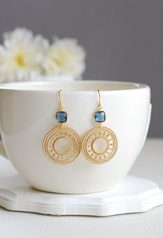 Beautiful matte gold round filigree pendants dangle from sparkly Montana blue framed glass stones. These earrings measure approx. 2.1 inches (54mm) from top to bottom. Ear wires are tarnish resistant gold plated over brass. ♥ Click the link below to see more beautiful modern earrings Gold Boho Earrings, Elegant Blue Circular Jewelry, Blue Filigree Dangle Jewelry, Jóias Body Chains, Dark Earrings, Navy Blue Earrings, Photographing Jewelry, Jewellery Photography Inspiration, Creative Jewelry Photography