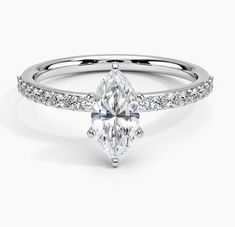 a white gold engagement ring with an oval cut diamond and pave set side stones