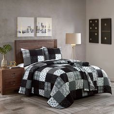 a black and white quilted bed in a bedroom