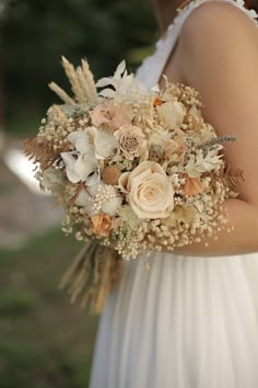 a bride holding a bouquet of flowers in her hands