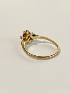 Fabulous 1980s era pear cut Citrine & diamond ring! This 10k yellow gold beauty features an approximate 3/4 carat pear cut citrine, surrounded by 2 round cut diamonds. Such a stunning and unique piece! ERA - Circa 1970s METAL / MATERIAL - 10k yellow gold, one pear cut citrine (approx. .71ct), 2 round cut diamonds (.06 ctw) MARKINGS / HISTORY - Inside of band is marked 10k CONDITION - Good condition. Stones are all secure. Some light age appropriate wear. Amazing vintage ring! SIZE / MEASUREM Vintage Yellow Rings With Prong Setting, Vintage Pear-shaped Diamond Cut Ring, Vintage Pear-shaped Diamond Ring With Brilliant Cut, Vintage Pear-shaped Brilliant Cut Diamond Ring, Classic Pear-shaped Diamond Ring In 14k Gold, Vintage Yellow Gold Pear-shaped Diamond Ring, Classic Gold Diamond Pear Ring, Vintage Pear-shaped Yellow Gold Diamond Ring, Vintage Pear-shaped Diamond Ring With Prong Setting