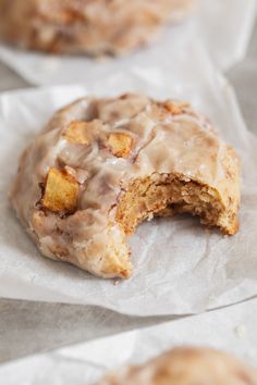 a doughnut that has been cut in half and is sitting on some wax paper