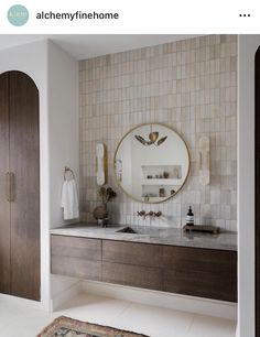 a bathroom with a sink, mirror and cabinets