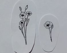 two nail decals with flowers drawn on them