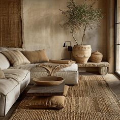 a living room filled with lots of furniture and decor on top of a wooden floor