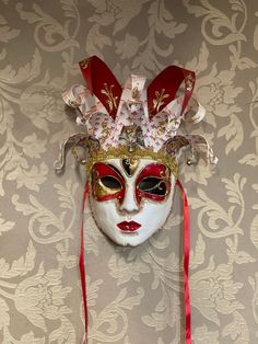 Original Venetian papier-mache mask made entirely by hand and hand-decorated with acrylic colors.It can be worn through the laces or used as a decoration of the house.Being handmade each piece is unique.All our masks are handmade by our staff (me, my wife and our collaborators) in our atelier in Venice. The masks are all made of paperweight and are made using ancient techniques from the 1300sThey are decorated with acrylic colors, gold leaf, silver leaf, trifies, lace and Swarovski crystals so a Hand Painted Masks And Prosthetics For Carnival, Traditional Masks For Carnival Gifts, Traditional Carnival Masks As Gifts, Festival Masks And Prosthetics As Gifts, Hand Painted Masks For Masquerade Carnival, Hand Painted Masks For Carnival Masquerade, Venetian Masks For Themed Carnival Events, Hand Painted Carnival Masks, Artistic Red Masks And Prosthetics For Costume