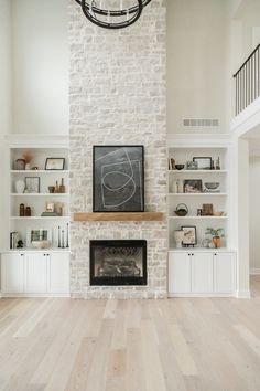 a living room filled with furniture and a fire place in front of a brick wall