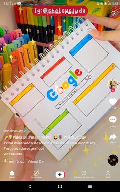 someone is holding up a google calendar in front of a bunch of colored pencils