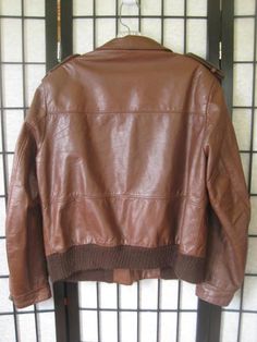 Fine quality vintage leather jacket by Sears, The Leather Shop. Caramel/mahogany brown. Photos get the color accurately. Nice detail seaming and back. Label size 42R - please note measurements below Chest/Bust (armpit to armpit) is 44 inches - interior measure. Bottom edge (ribbing) is 42 inches with easy stretch to 46 inches. Sleeve is 25-1/2 inches. Shoulder seam to seam is 17-1/2 inches. Length is 24-1/2 inches. Zipper closure. Cloth lining in the pockets. Some pilling on the knit ribbing at Retro Brown Leather Jacket For Winter, Vintage Brown Retro Leather Jacket For Winter, Retro Brown Leather Outerwear, Vintage Brown Leather Biker Jacket, Retro Brown Leather Jacket, Retro Distressed Brown Leather Jacket For Winter, Vintage Brown Long Sleeve Biker Jacket, Retro Brown Leather Jacket For Fall, Retro Distressed Brown Leather Jacket For Fall