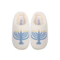 a pair of white slippers with a blue menorah design on the front