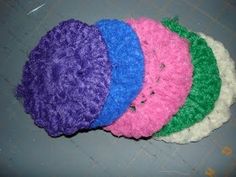 four crocheted donuts sitting on top of a table