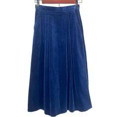 "Vintage 1970s Blue Velvet Maxi Pleated Skirt - A-Line Skirt Vintage - Size XS - 70s Vintage Skirt  Midnight blue velvet maxi A-Line skirt from the 70s. Zipper closure in the back. Two front pockets. Pleating on front and back. Some wear around zipper and back of skirt from sitting, not very noticeable with material. Maxi skirt, about mid calf length.  Marked 5-6, modern size XS Measurements: Waist 24\" Hips 34\" Length 30\"" Retro Long Blue Skirt, Vintage Blue Pleated Skirt, Vintage Blue Pleated Skirt Bottoms, Retro Blue Pleated Skirt, Vintage Blue Full Skirt, Retro Blue Lined Skirt Bottoms, Retro Blue Lined Skirt, Retro Blue Flared Skirt Bottoms, Retro Blue Midi Skirt