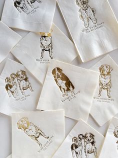 many different types of dogs printed on white paper napkins with gold foil stamping