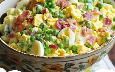 a bowl filled with eggs, peas and ham