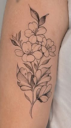 a black and white flower tattoo on the arm